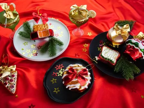 New Year's desserts. Creative table setting with Christmas tree toys. Stock Photos