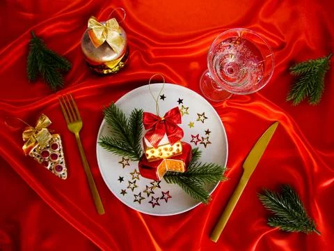 New Year's desserts. Creative table setting with Christmas tree toys. Stock Photos