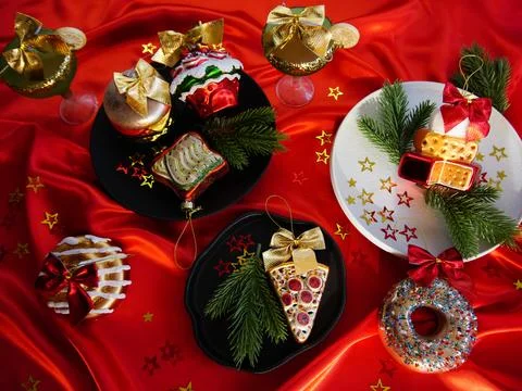 New Year's desserts. Creative table setting with Christmas tree toys. Stock Photos