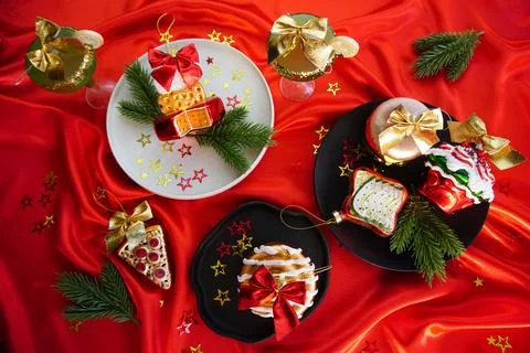 New Year's desserts. Creative table setting with Christmas tree toys. Stock Photos