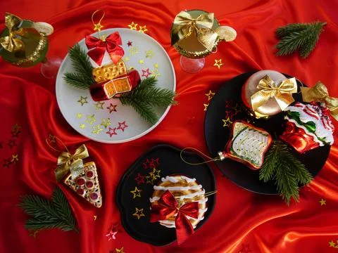 New Year's desserts. Creative table setting with Christmas tree toys. Stock Photos