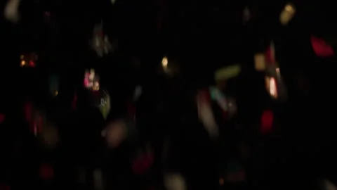 New Years Eve Hand Throws Confetti - Confetti Falls and Reflects 스톡 동영상 297635136