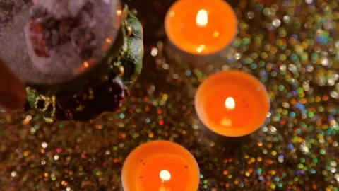 New Year's gift on the background of lit candles and shine Stock Footage 83236748