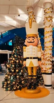 New Year's Nutcracker statue stands in front of a Christmas tree Stock Photos