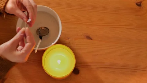 New Years party  tin casting set. woman examines a piece of molten tin Stock Footage 288881116