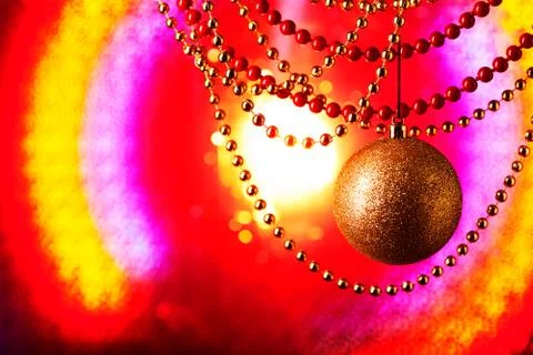 New Year's plot. Golden sphere. Iridescent background. Multi-colored garlands Stock Photos
