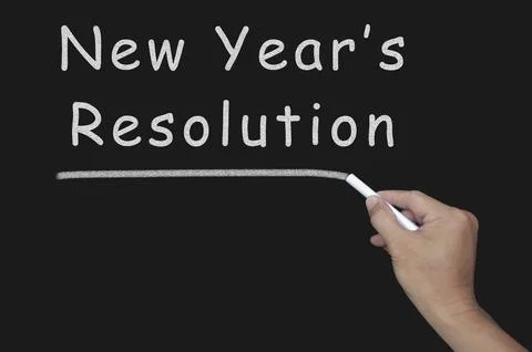 New Year's Resolution text on blackboard. Stock Photos