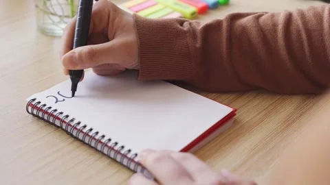 New year's resolutions concept. Hand writing 2024 in notebook Stock Footage 256609766