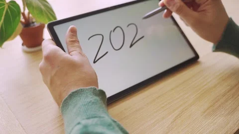 New year's resolutions. Hand with pen writing in tablet 2025 Stock Footage 290237366