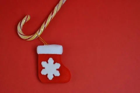 New Years stocking and candy cane. Red background. Christmas and New Year. Foto stock