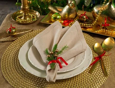 New Year's table setting in gold color with a linen napkin Stock Photos
