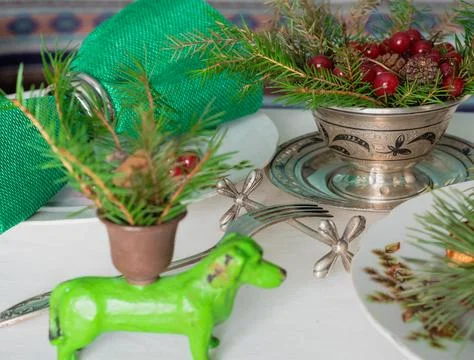 New Year's table setting with linen tablecloth, candles and spruce branches Stock Photos
