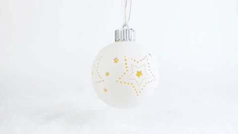 New Year's white Christmas tree toy hangs, falls on the snow, gift rotation. Stock Footage 222390084