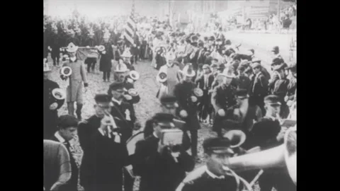 NEW YORK 1900s: Parade: marching band, firemen carrying a banner, firemen Stock Footage 332086182