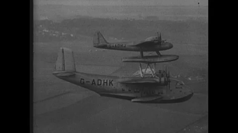 NEW YORK 1930S: A twin-engine propeller aircraft with landing gear extended 動画素材 342037885