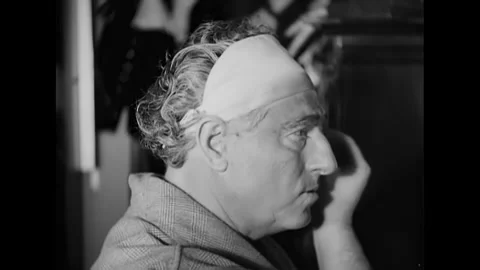 NEW YORK - 1935 - The opera singer applies make-up backstage. A conductor Stock Footage 341973302