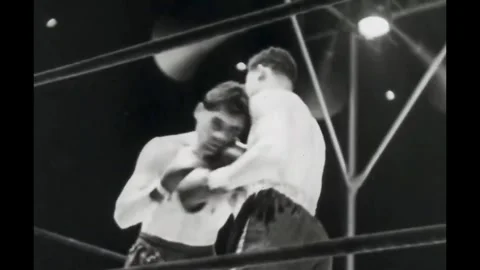 NEW YORK - 1936 - Max Schmeling knocks Joe Louis to the ground after twelve Stock Footage 341987922