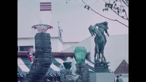 NEW YORK - 1939 - Water flows from a fountain adorned with colorful glass beside Stock Footage 327754763