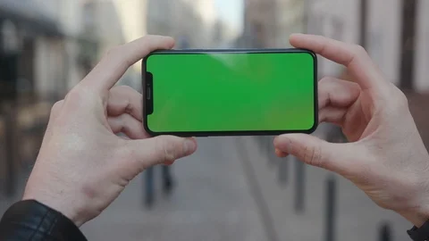 NEW YORK - April 5, 2018: Close up hands young man holding a smartphone with Stock Footage 112157474