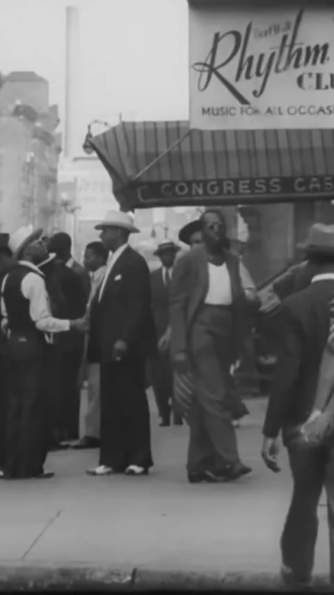 NEW YORK CITY - 1939 - Cops and firemen talk on a Harlem street, and a fire Stock Footage 342263448