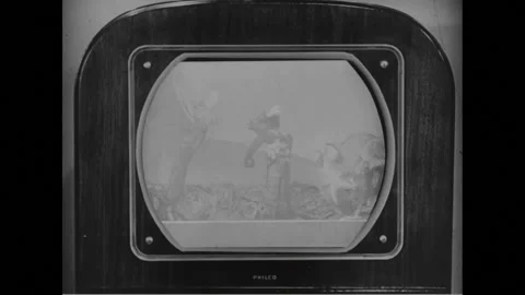 NEW YORK CITY 1940s: Group of children watch puppet show on TV. Children laugh. Stock Footage 300397699