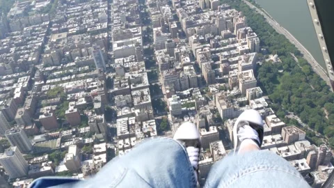 New York City doors off helicopter flight, Manhattan USA. Feet in sneakers, legs Stock Footage 284046292