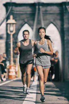New York city runners athletes training jogging on Brooklyn Bridge for Marathon Stock Photos