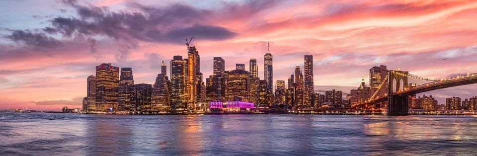 New york city skyline travel destination at dramatic sunset over manhatten Stock Photos
