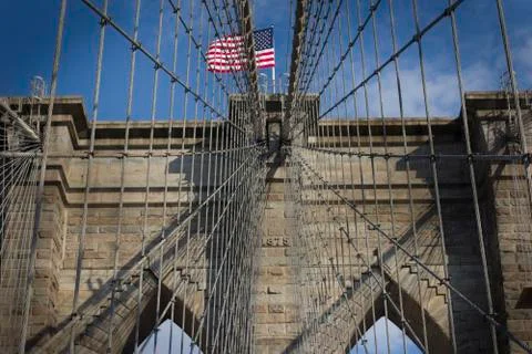 The New York flag captured through the cable wires of the Brooklyn Bridge Stock Photos