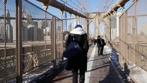 NEW YORK - JAN 15 Slow Motion Pedestrians walk over the Brooklyn Bridge Stock Footage 74642068