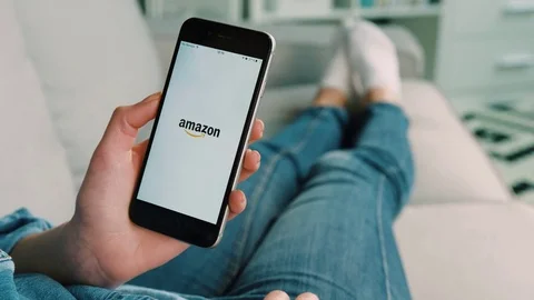 New York - March 10, 2017: Woman hands using Amazon on the smart phone for Stock Footage 75876705