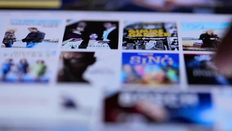 New York - May 06, 2017: Browsing a movie video to watch on ipad tablet computer Stock Footage 80217405