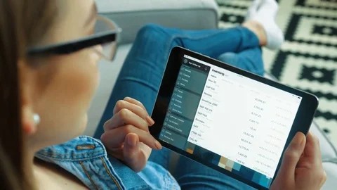 New York - May 15, 2017: Woman using Investing app on black tablet computer Video stock 76454891