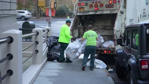 New York sanitation workers loading garbage truck Stock Footage 165710258