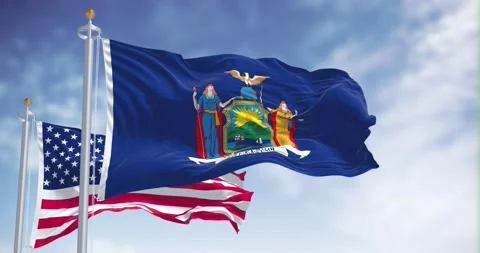 The New York state flag waving along with the national flag of the US Video stock 192371196