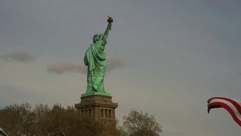 New York: Statue of Liberty, with american flag, ultra hd 4k Stock Footage