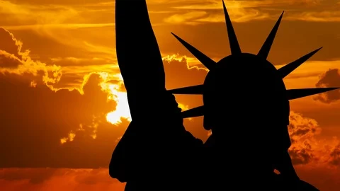 New York: Statue of Liberty at Sunset, with Red Sun and Clouds Manhattan, USA Stock Footage 101677835