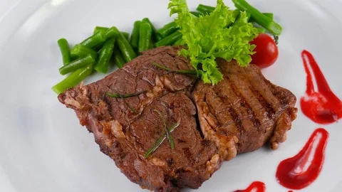 The New York Strip Beef steak with green beans Stock Footage 79714274