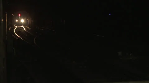 New York Subway train light approaches and swings close past camera Vidéo 39614283