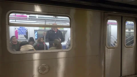 New York Subway train pulls away from station 4k Stock Footage