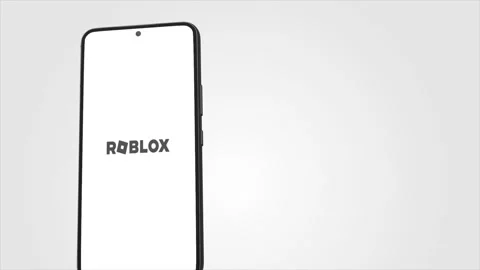 Foto de Roblox logo and application on the mobile screen. Roblox