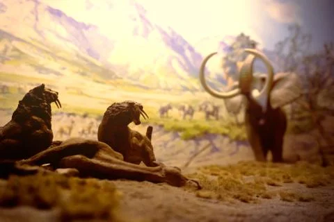 New york, USA, November 2018 - prehistoric hunting scene with mammoths and sm Stock Photos
