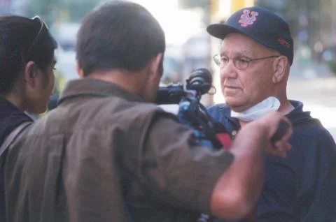 New Yorker is interviewed on camera for TV news story on 9/11 in NYC Stock Photos