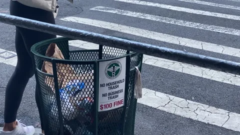 New Yorker throws away bit of rubbish in Manhattan Trash Bin or Trashcan Stock Footage 166320833