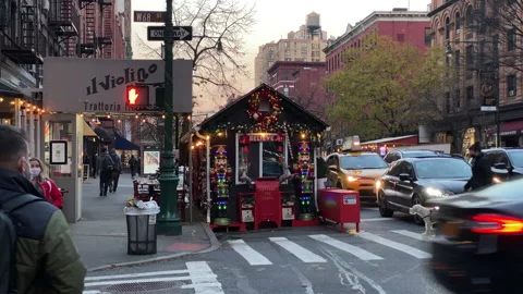 New Yorkers pass by a tiny sidewalk curbside pop-up Christmas shop Stock Footage 146099401