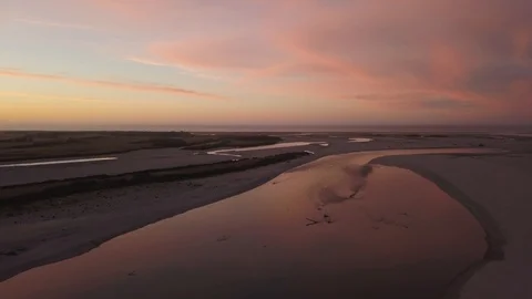 New Zealand - Haast, Pink and Red Sunset Over Calm River Aerial Long Stock Footage