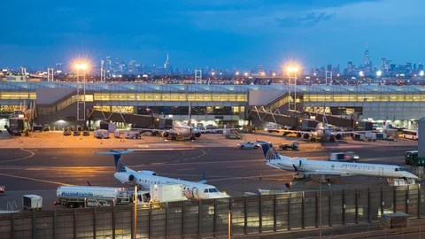 Newark EWR Airport Night Timelapse with NYC Skyline Background Stock Footage