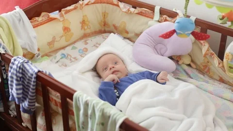The newborn is awake in the crib Vídeo Stock 85637379