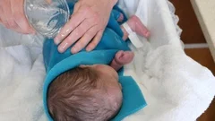 https://images.pond5.com/newborn-baby-girl-getting-bathed-footage-089677715_iconm.jpeg