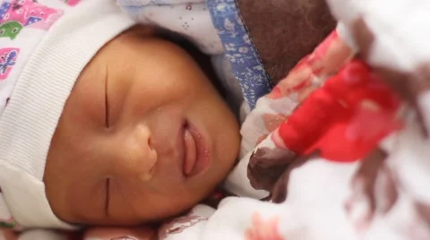 Newborn baby grimacing while sleeping Stock Footage 55339975